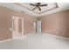 Spacious bedroom with a ceiling fan and neutral color palette, creating a relaxing atmosphere at 8539 Via Bella Notte, Orlando, FL 32836