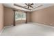 Bedroom with neutral walls, carpet, ceiling fan and natural light from window at 8539 Via Bella Notte, Orlando, FL 32836
