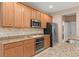 Kitchen featuring wood cabinets, granite countertops, stainless steel appliances at 8539 Via Bella Notte, Orlando, FL 32836
