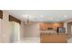 The kitchen and living room with granite countertops and stainless steel appliances at 8539 Via Bella Notte, Orlando, FL 32836