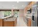 Spacious kitchen featuring granite countertops, wood cabinets, and stainless steel appliances at 8539 Via Bella Notte, Orlando, FL 32836