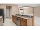 Kitchen with granite countertops, wood cabinets, and stainless steel dishwasher at 8539 Via Bella Notte, Orlando, FL 32836