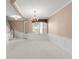 Living room with a chandelier, staircase, carpet, and lots of natural light at 8539 Via Bella Notte, Orlando, FL 32836