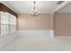 Open living room with a chandelier, carpet, and picture window at 8539 Via Bella Notte, Orlando, FL 32836