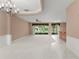 Spacious living room featuring carpet, sliding doors, and a wet bar at 8539 Via Bella Notte, Orlando, FL 32836