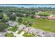 Aerial view of a residential area featuring mature trees, lush landscaping, and green lawns at 9 Abbey Ct, Haines City, FL 33844