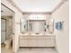 Clean bathroom with a double vanity, large mirror, and a toilet at 9 Abbey Ct, Haines City, FL 33844