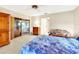 Bedroom featuring a bed, dresser, floral print couch, and sliding glass doors to the sunroom at 9 Abbey Ct, Haines City, FL 33844