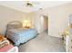 Bedroom showcasing a bed, dresser, and access to other rooms within the home at 9 Abbey Ct, Haines City, FL 33844