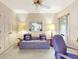 Cozy bedroom featuring a comfortable sofa, ceiling fan, and closet at 9 Abbey Ct, Haines City, FL 33844