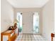 Bright foyer with neutral walls, tile floors, and decorative accents leading to the rest of the home at 9 Abbey Ct, Haines City, FL 33844