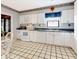 Bright kitchen with white cabinets, standard appliances, and decorative accents at 9 Abbey Ct, Haines City, FL 33844