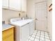 Functional laundry room equipped with a washer, dryer, and storage cabinets at 9 Abbey Ct, Haines City, FL 33844