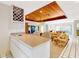 Open-concept living room featuring a wooden accent ceiling, wet bar, and seamless transition to the outdoor space at 9 Abbey Ct, Haines City, FL 33844