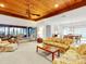 Inviting living room featuring a wood-paneled ceiling, access to the patio, and adjacent dining area at 9 Abbey Ct, Haines City, FL 33844