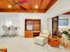 Cozy living area with a built-in bookshelf, wet bar, and comfortable seating, seamlessly connecting to the outdoors at 9 Abbey Ct, Haines City, FL 33844