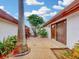 Charming patio area featuring a sliding glass door, decorative paving, and tropical landscaping at 9 Abbey Ct, Haines City, FL 33844