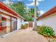 Enclosed patio area showcases decorative paving, mature landscaping, and a gated entrance at 9 Abbey Ct, Haines City, FL 33844