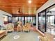 Spacious sun room with wicker seating, wood ceilings, and access to the outdoors at 9 Abbey Ct, Haines City, FL 33844