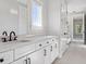 Elegant bathroom showcasing a long vanity with double sinks, white cabinetry, and modern fixtures at 9155 Sheen Sound St, Orlando, FL 32836