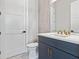 Stylish powder room featuring a modern vanity with gold fixtures and decorative tile accent wall at 9155 Sheen Sound St, Orlando, FL 32836