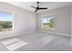 Spacious bedroom with carpet, ceiling fan, and two large windows providing ample natural light at 9155 Sheen Sound St, Orlando, FL 32836