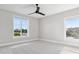 Bright bedroom with large windows, ceiling fan, and views of the outdoors at 9155 Sheen Sound St, Orlando, FL 32836