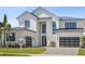 Charming two-story home with lush landscaping, black-trimmed windows, and a modern garage at 9155 Sheen Sound St, Orlando, FL 32836