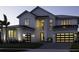 Stunning two-story home with black-trimmed windows, modern lighting, and three-car garage at 9155 Sheen Sound St, Orlando, FL 32836