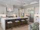 Modern kitchen boasts a large island, stainless steel appliances, and ample counter space at 9155 Sheen Sound St, Orlando, FL 32836