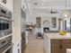 Open floor plan view of kitchen and living room, featuring fireplace and modern lighting at 9155 Sheen Sound St, Orlando, FL 32836