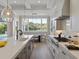 Bright kitchen showcasing marble countertops, stainless gas range, and large view window at 9155 Sheen Sound St, Orlando, FL 32836