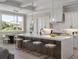 Elegant kitchen showcasing a large island with seating and modern pendant lighting at 9155 Sheen Sound St, Orlando, FL 32836