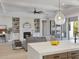 Open concept living space with kitchen island, fireplace, and access to outdoor grill at 9155 Sheen Sound St, Orlando, FL 32836