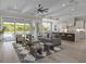 Bright living room with hardwood floors, an open kitchen, and sliding glass doors to the backyard at 9155 Sheen Sound St, Orlando, FL 32836