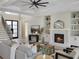 Bright living room with a fireplace, built-in shelves, and a console table at 9155 Sheen Sound St, Orlando, FL 32836