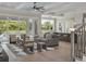 Spacious living room featuring hardwood floors, an open kitchen, and sliding glass doors at 9155 Sheen Sound St, Orlando, FL 32836