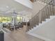 Bright, open-concept living area with hardwood floors, a staircase, and views to the backyard at 9155 Sheen Sound St, Orlando, FL 32836