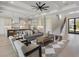 Open-concept living area with a staircase, large fan, and view of the front door at 9155 Sheen Sound St, Orlando, FL 32836