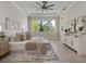 Serene main bedroom featuring a large window with natural light, neutral tones, and modern furnishings at 9155 Sheen Sound St, Orlando, FL 32836