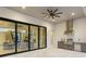 Spacious outdoor living area with views into living and dining areas, featuring a fully-equipped outdoor kitchen at 9155 Sheen Sound St, Orlando, FL 32836