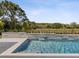 Relaxing in-ground pool with stone accents and serene green landscape views at 9155 Sheen Sound St, Orlando, FL 32836