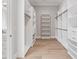 Large walk-in closet with custom shelving and wood floors for organized storage at 9155 Sheen Sound St, Orlando, FL 32836