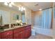 Bathroom with dual sinks, a large mirror, and a bathtub-shower combination at 101 S Eola Dr # 621, Orlando, FL 32801
