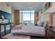 Well lit bedroom with modern decor and large windows offering city views at 101 S Eola Dr # 621, Orlando, FL 32801