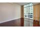 Empty bedroom showcasing hardwood floors and floor-to-ceiling windows at 101 S Eola Dr # 621, Orlando, FL 32801