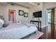Bright bedroom featuring a comfortable bed, decorative accents, and hardwood floors at 101 S Eola Dr # 621, Orlando, FL 32801