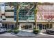 Inviting entrance of building 101 Eola with palm trees, street view, and modern architecture at 101 S Eola Dr # 621, Orlando, FL 32801