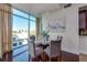 Dining area with glass table and modern chairs, showcasing city views from large windows at 101 S Eola Dr # 621, Orlando, FL 32801