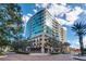Stunning building exterior featuring modern architecture, glass facade, and street-level dining at 101 S Eola Dr # 621, Orlando, FL 32801